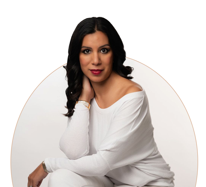 A woman with long, dark hair poses against a neutral background, wearing a white off-shoulder top and a warm expression.
